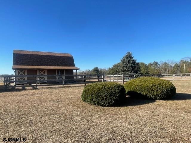 view of yard featuring an outbuilding and a rural view