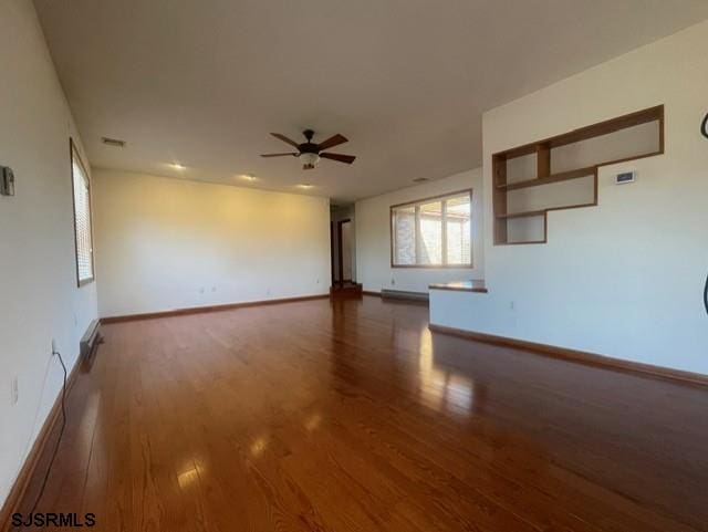 unfurnished room featuring dark hardwood / wood-style flooring and ceiling fan