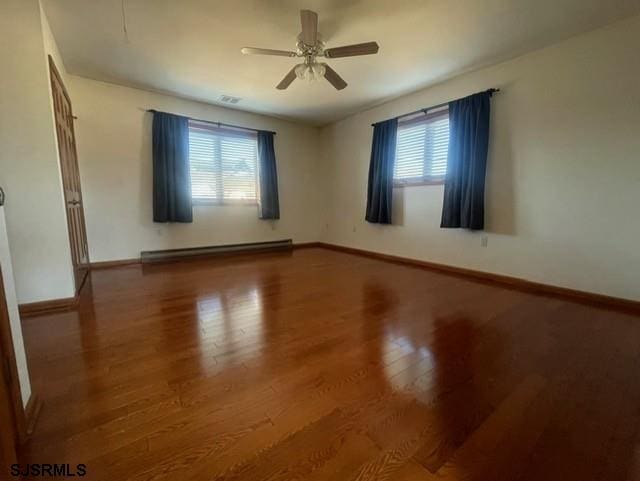 unfurnished room with hardwood / wood-style flooring, ceiling fan, and a baseboard radiator