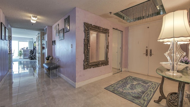 hallway with tile patterned flooring and a textured ceiling