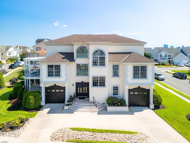 view of front facade with a balcony and a garage