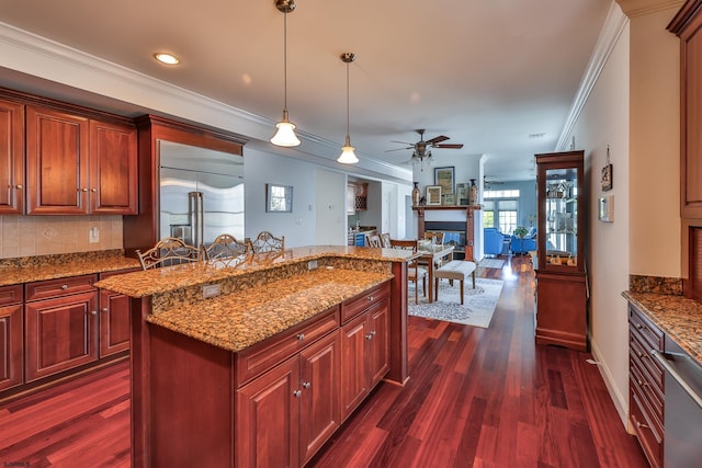 kitchen with crown molding, ceiling fan, tasteful backsplash, decorative light fixtures, and dark hardwood / wood-style flooring