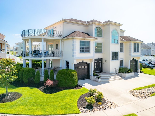 mediterranean / spanish home featuring a balcony, a front lawn, and a garage