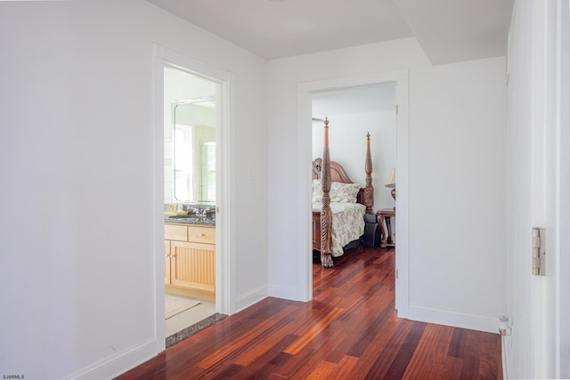 hall with dark hardwood / wood-style floors and sink