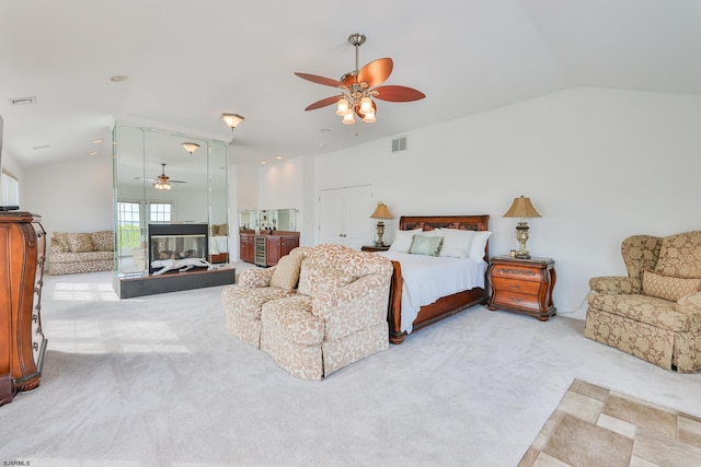 carpeted bedroom featuring vaulted ceiling and ceiling fan