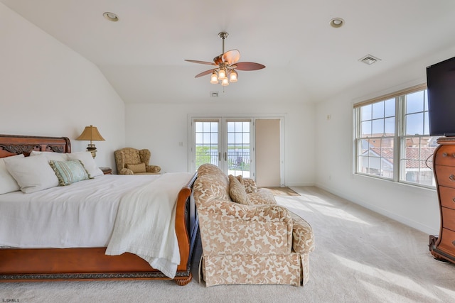 carpeted bedroom with ceiling fan, lofted ceiling, and multiple windows