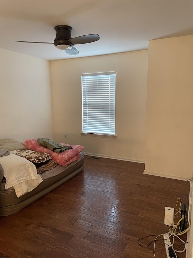 bedroom with ceiling fan and dark hardwood / wood-style floors