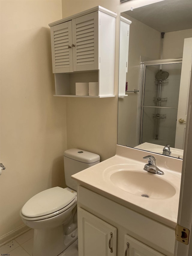 bathroom featuring tile patterned flooring, vanity, an enclosed shower, and toilet