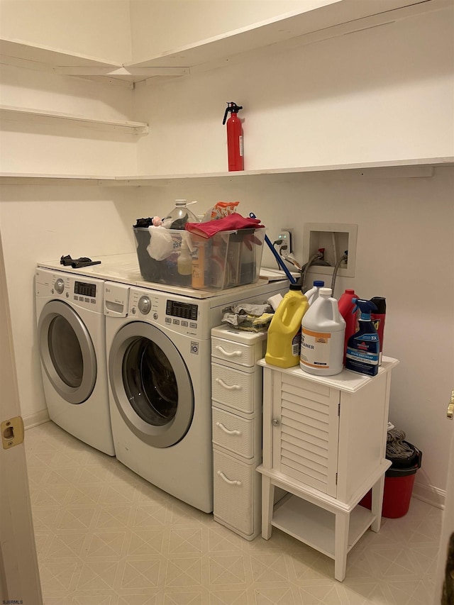 clothes washing area with washing machine and dryer