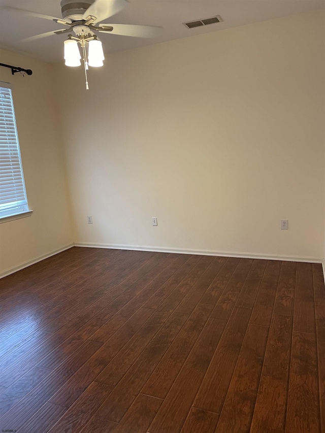 unfurnished room with ceiling fan and dark wood-type flooring