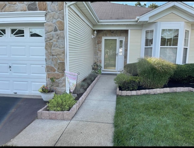 doorway to property with a garage