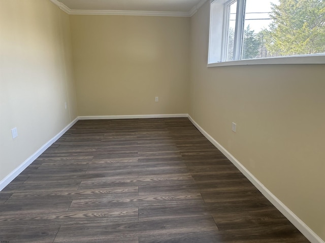 empty room featuring dark hardwood / wood-style floors and ornamental molding