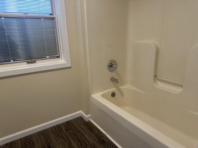 bathroom featuring  shower combination and hardwood / wood-style flooring