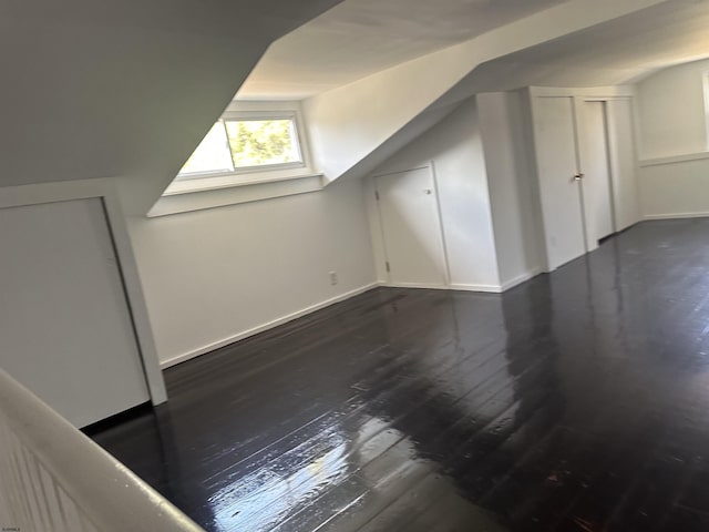 additional living space featuring dark hardwood / wood-style floors