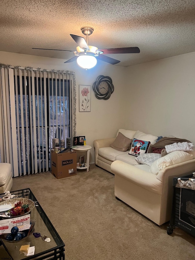 living room featuring carpet, a textured ceiling, and ceiling fan