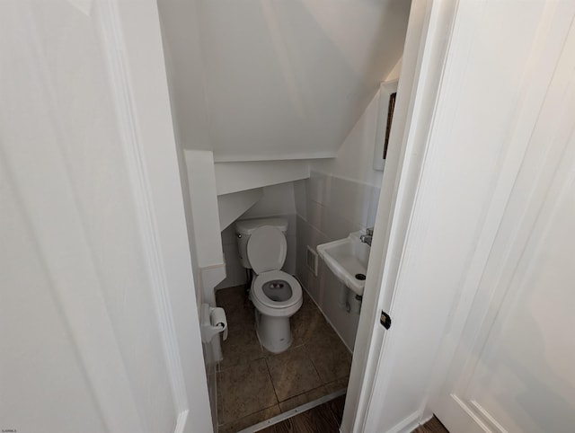 bathroom featuring sink, tile patterned flooring, and toilet