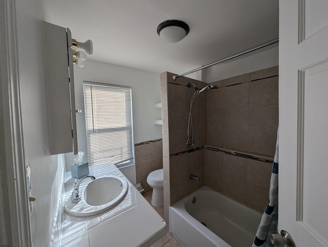 full bathroom with toilet, shower / bath combo, vanity, and tile patterned floors