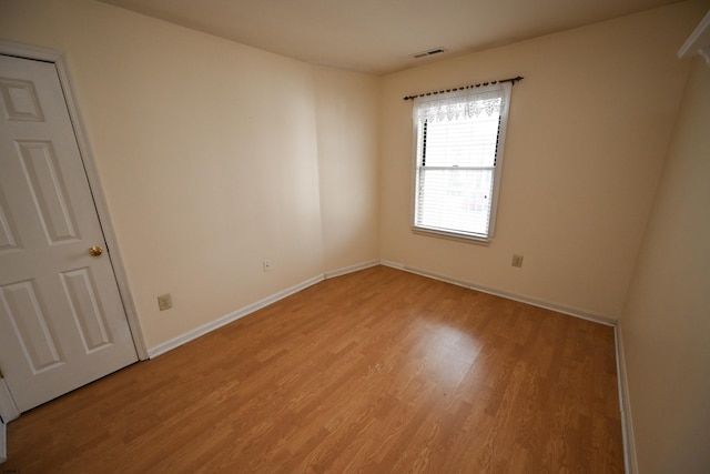 unfurnished room with light hardwood / wood-style floors