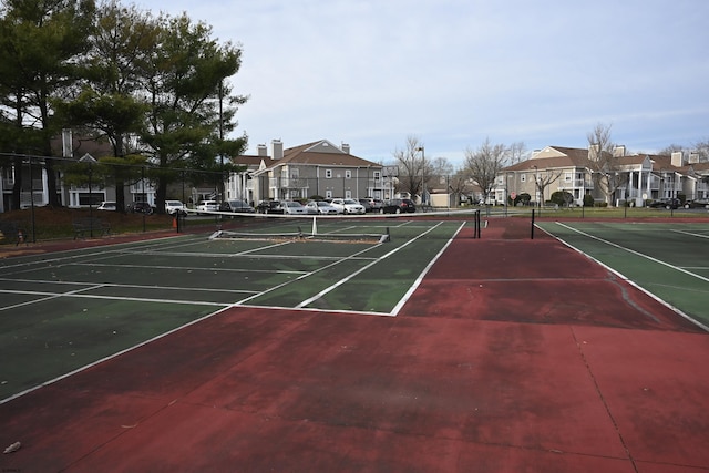 view of tennis court featuring basketball court