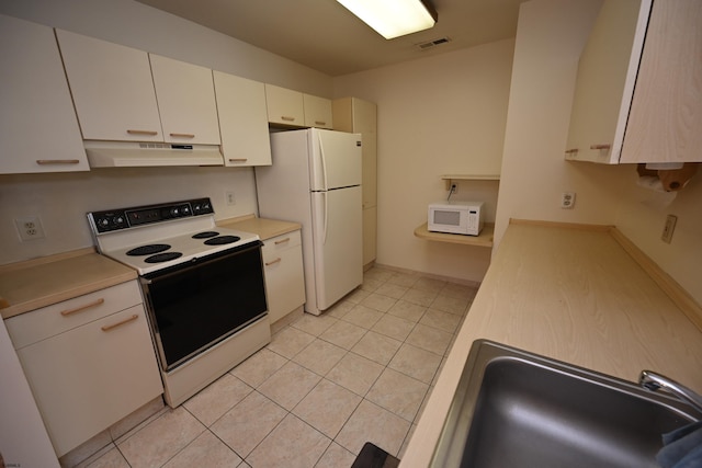 kitchen featuring light tile patterned flooring, white appliances, sink, and white cabinetry