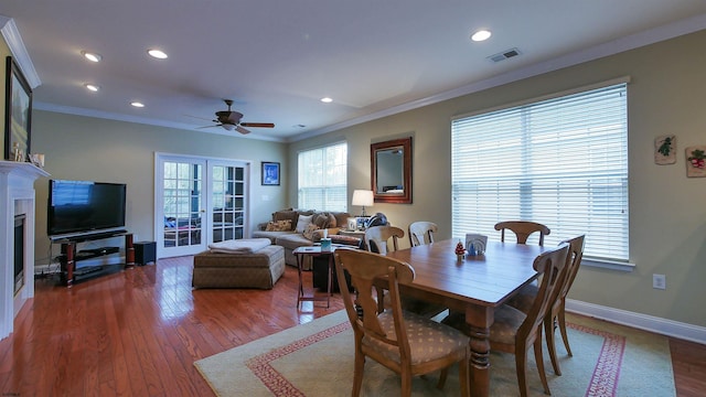 dining area featuring crown molding, french doors, ceiling fan, and dark hardwood / wood-style floors