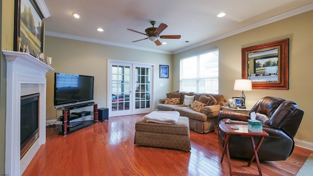 living room with hardwood / wood-style flooring, ceiling fan, ornamental molding, and french doors