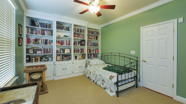 bedroom featuring light colored carpet, ceiling fan, and crown molding