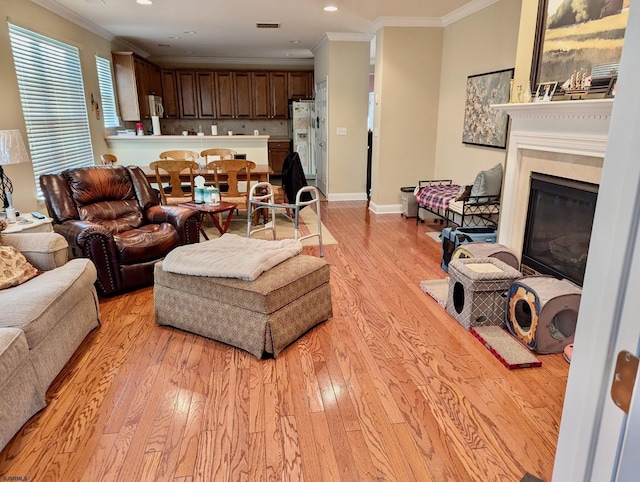 living room featuring light hardwood / wood-style floors and crown molding