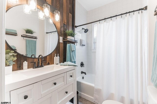 bathroom featuring shower / bath combo with shower curtain and vanity