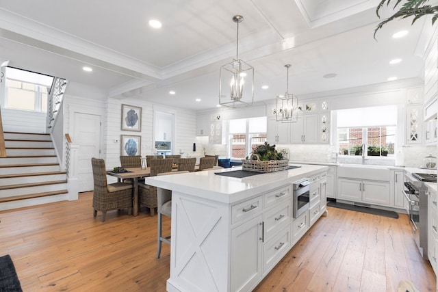 kitchen featuring backsplash, a breakfast bar, a center island, and white cabinets