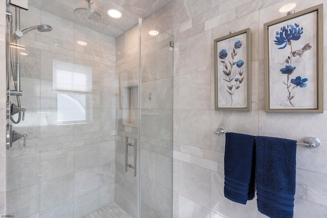 bathroom featuring a shower with shower door