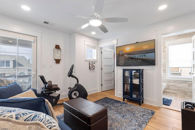 living room featuring ceiling fan and light wood-type flooring