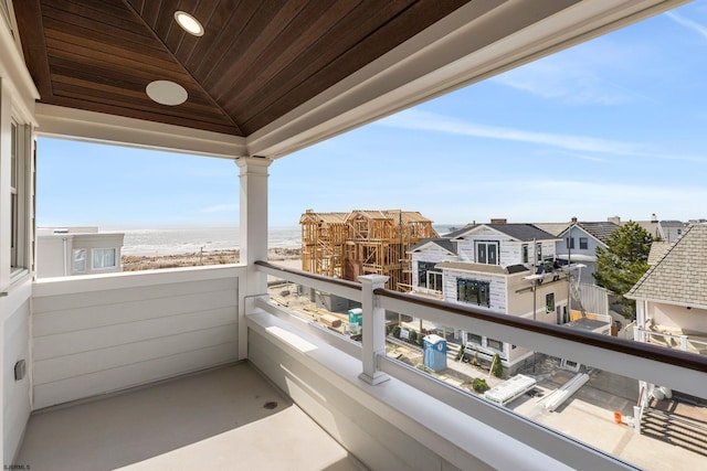 balcony with a beach view and a water view