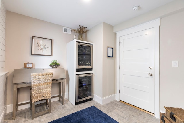 interior space with light parquet flooring and beverage cooler