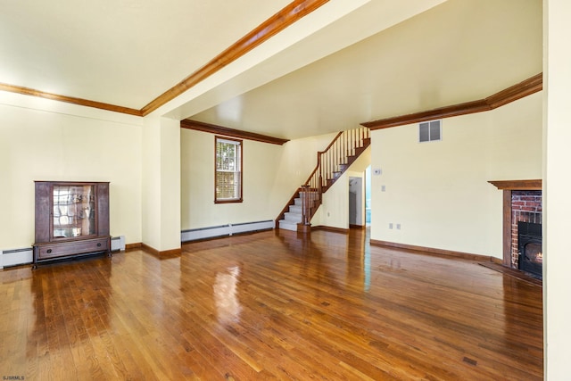 unfurnished living room with a brick fireplace, hardwood / wood-style flooring, ornamental molding, and a baseboard heating unit