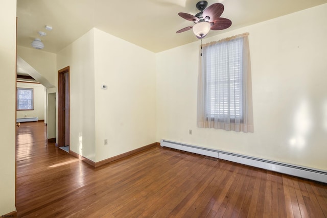 empty room with hardwood / wood-style flooring, a baseboard radiator, and ceiling fan