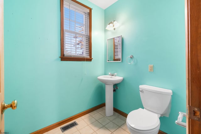 bathroom featuring tile patterned floors, toilet, and sink