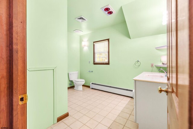 bathroom with tile patterned flooring, vanity, toilet, and a baseboard heating unit