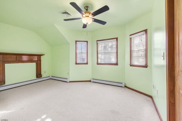 additional living space featuring baseboard heating, ceiling fan, plenty of natural light, and vaulted ceiling