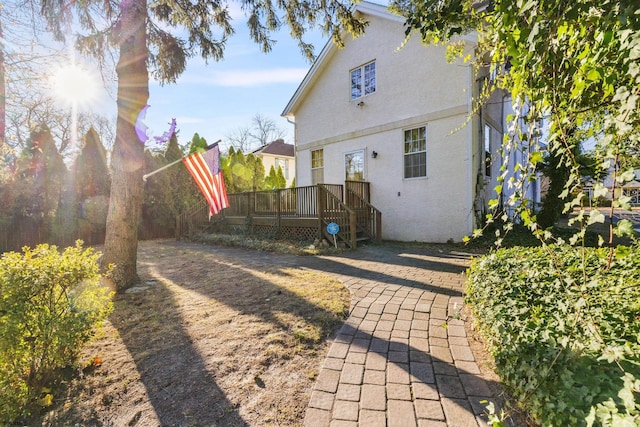 back of house featuring a wooden deck