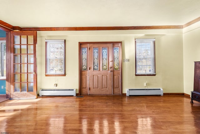 entrance foyer featuring hardwood / wood-style flooring and a baseboard heating unit