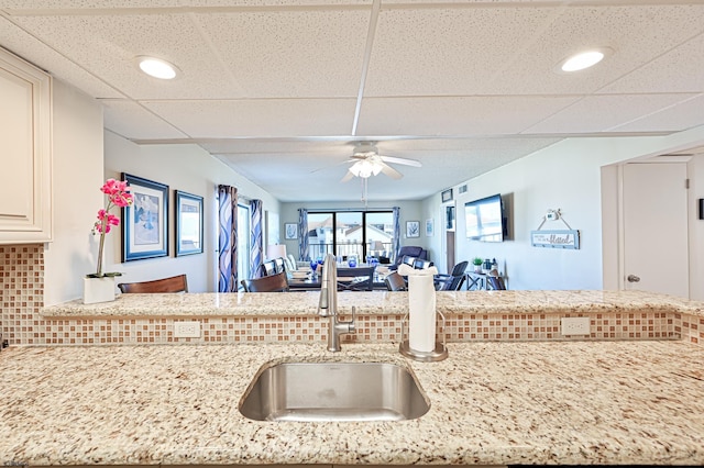 4540 W Brigantine Ave Unit N201, Brigantine, NJ 08203 - kitchen with a sink, tasteful backsplash, light stone countertops, a ceiling fan, and open floor plan