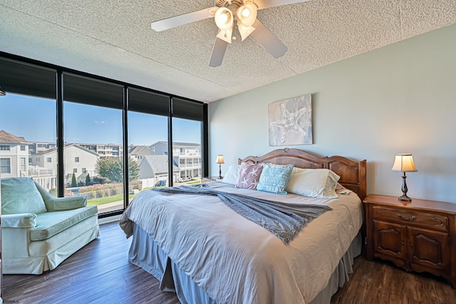 4540 W Brigantine Ave Unit N201, Brigantine, NJ 08203 - bedroom featuring dark wood finished floors, a wall of windows, a ceiling fan, a textured ceiling, and a residential view