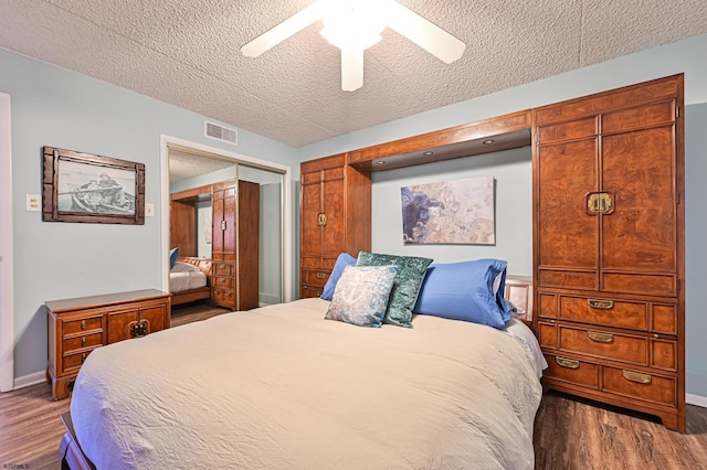 4540 W Brigantine Ave Unit N201, Brigantine, NJ 08203 - bedroom with wood finished floors, a closet, a textured ceiling, baseboards, and a ceiling fan