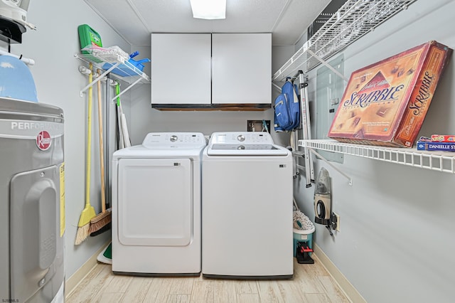 4540 W Brigantine Ave Unit N201, Brigantine, NJ 08203 - washroom featuring washing machine and clothes dryer, cabinet space, light wood-type flooring, and baseboards