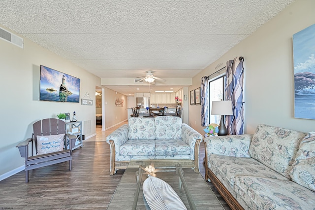 4540 W Brigantine Ave Unit N201, Brigantine, NJ 08203 - living area with dark wood finished floors, ceiling fan, baseboards, and a textured ceiling