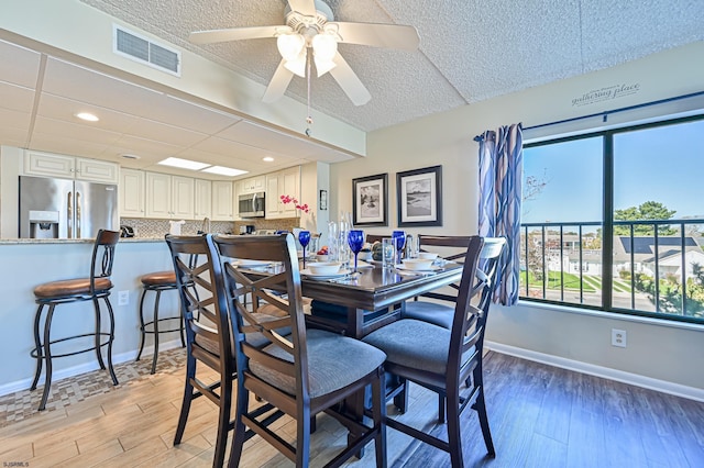 4540 W Brigantine Ave Unit N201, Brigantine, NJ 08203 - dining space featuring plenty of natural light, light wood-style flooring, a textured ceiling, baseboards, and ceiling fan