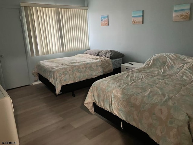 bedroom with hardwood / wood-style flooring