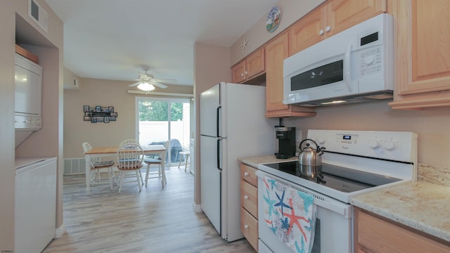 kitchen with white appliances, stacked washer and clothes dryer, light hardwood / wood-style flooring, ceiling fan, and light brown cabinetry