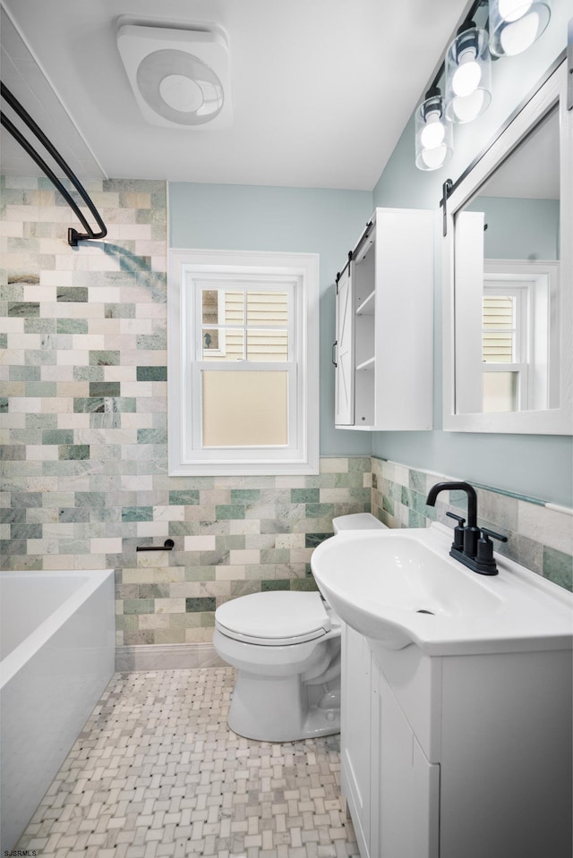 full bathroom featuring shower / bathtub combination, vanity, tile walls, and toilet